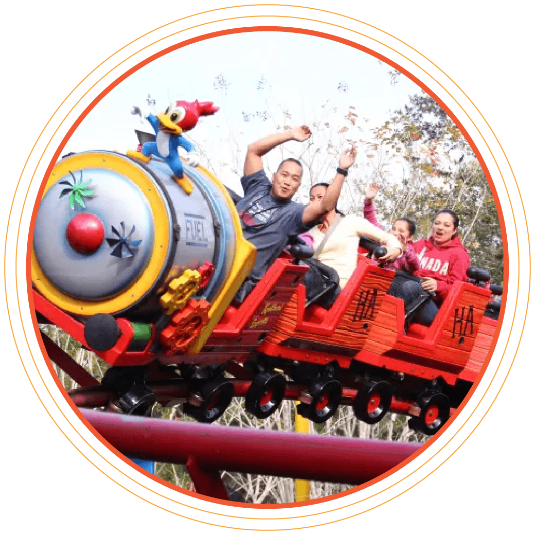 Photo of rollercoaster, close-up, smiling people with hands in the air.